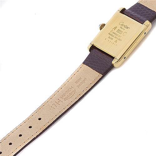 The image shows the back of a Cartier Tank Classic Yellow Gold Beige Dial Yellow Gold Beige Dial watch, displaying its caseback and leather strap, laid flat.