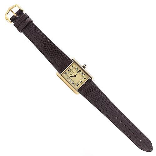 The Cartier Tank Classic Yellow Gold Beige Dial Yellow Gold Beige Dial watch is shown from a top-down angle, displaying the rectangular face, leather strap, and buckle.