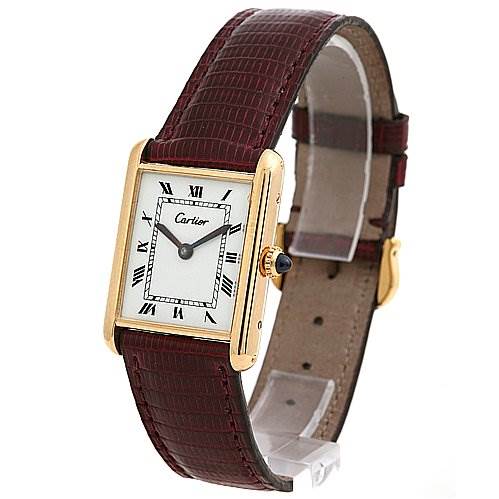The image shows a Tank Classic model by Cartier at a slight angle, highlighting the face, gold case, and brown leather strap.