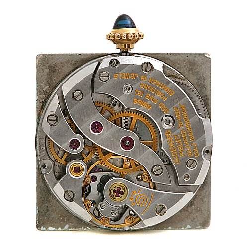 The image shows a close-up of the interior movement mechanism of the Cartier Tank Classic Yellow Gold White Dial Yellow Gold White Dial watch.