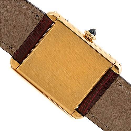 This is the back view of a Cartier Tank Classic Yellow Gold White Dial Yellow Gold White Dial watch, showing the case back, crown, and leather straps.