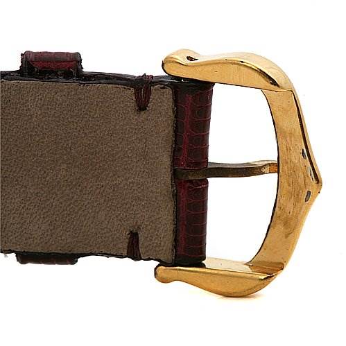 This image shows a close-up of the gold buckle and leather strap of the Tank Classic model by Cartier.