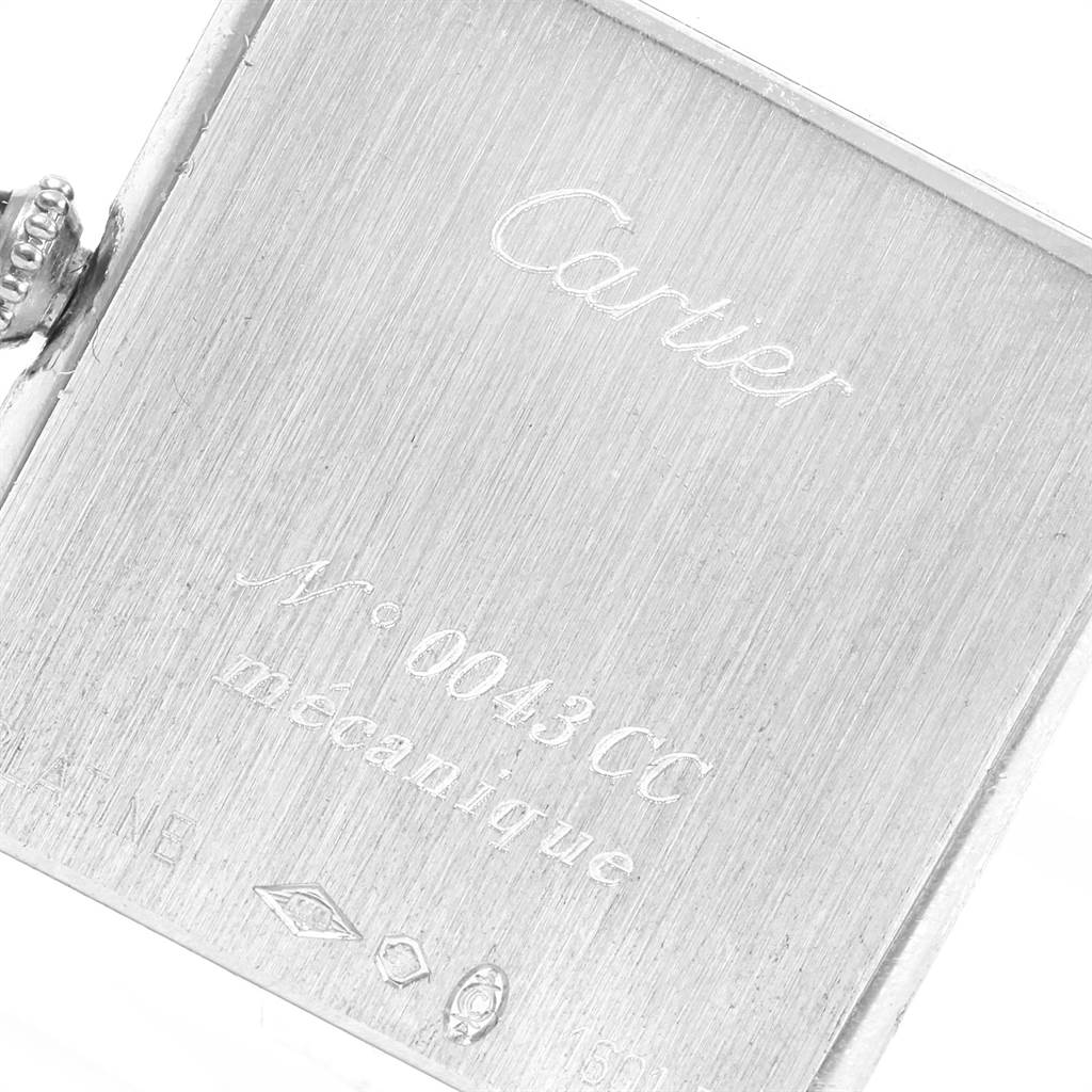 This close-up shows the engraved case back of the Cartier Tank Classic Men's Platinum Silver Dial Men's Platinum Silver Dial watch.