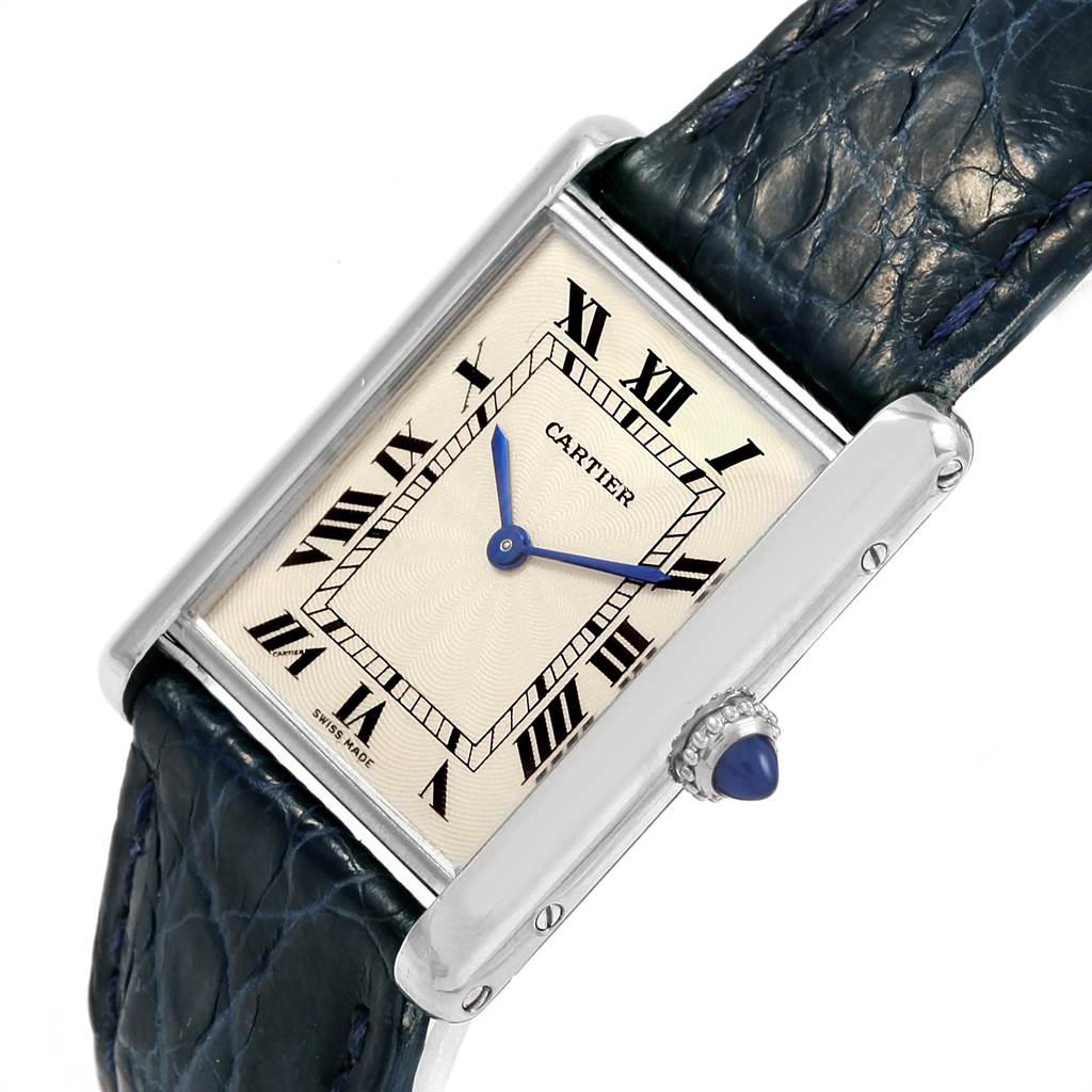 This image shows the Cartier Tank Classic Men's Platinum Silver Dial Men's Platinum Silver Dial watch at a slight angle, highlighting its dial, Roman numerals, blue hands, and leather strap.