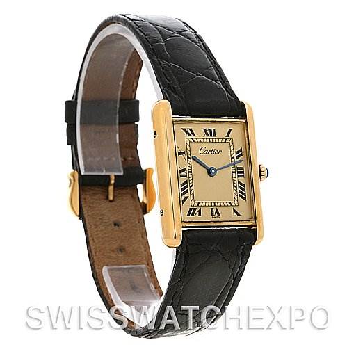 The image shows a Cartier Tank Classic Yellow Gold Champagne Dial Yellow Gold Champagne Dial watch angled from the front left, displaying the face, strap, and buckle.