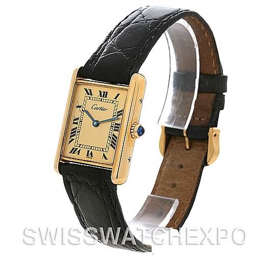 The image shows a Cartier Tank Classic Yellow Gold Champagne Dial Yellow Gold Champagne Dial watch angled to display its rectangular dial, leather strap, and side crown.