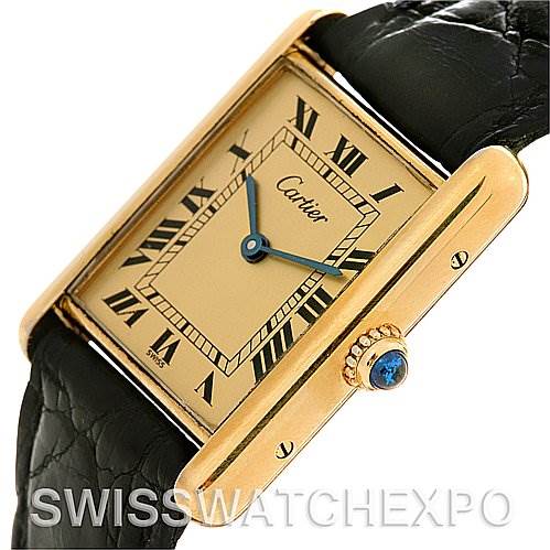 The image shows a close-up, top-angling view of a Cartier Tank Classic Yellow Gold Champagne Dial Yellow Gold Champagne Dial watch, highlighting its face, case, and strap.