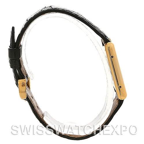 The Cartier Tank Classic Yellow Gold Champagne Dial Yellow Gold Champagne Dial watch is shown from the side, highlighting the case and buckle with a leather strap.