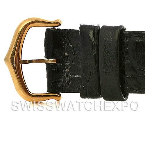 The image shows a close-up of the gold buckle and black leather strap of a Cartier Tank Classic Yellow Gold Champagne Dial Yellow Gold Champagne Dial watch.