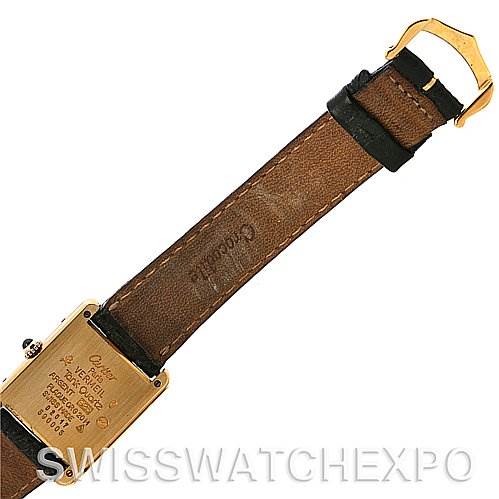 The image shows the back and strap of a Cartier Tank Classic Yellow Gold Champagne Dial Yellow Gold Champagne Dial watch taken from a top-down angle.