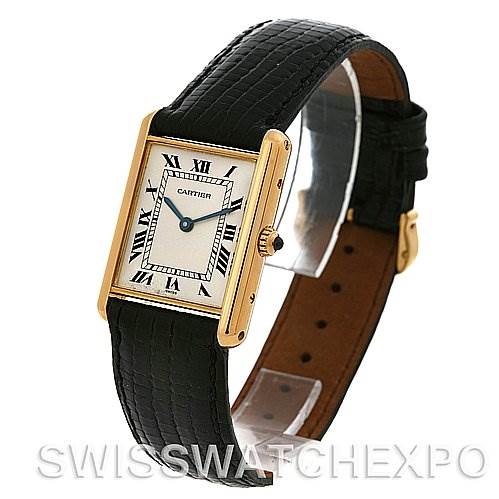 The image shows a Tank Classic model by Cartier angled to display its face, black alligator leather strap, and gold case.
