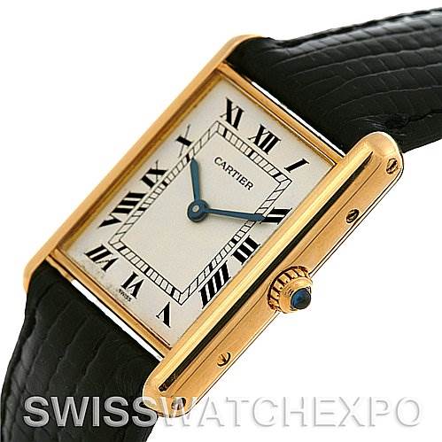 This image shows a close-up angle of the Cartier Tank Classic Yellow Gold White Dial Yellow Gold White Dial watch, highlighting the dial, Roman numerals, hands, bezel, and crown.