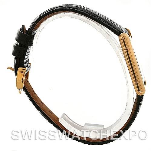 The image shows a Cartier Tank Classic Yellow Gold White Dial Yellow Gold White Dial watch from a side angle, highlighting its black leather strap and gold-toned rectangular case.