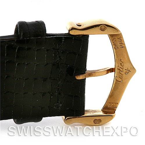 The image shows a close-up of the gold buckle and black leather strap of a Cartier Tank Classic Yellow Gold White Dial Yellow Gold White Dial watch.