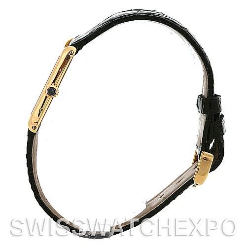 The image shows a side view of the Cartier Tank Classic 2466 Yellow Gold Silver Dial 2466 Yellow Gold Silver Dial watch, displaying its slim profile and black leather strap.