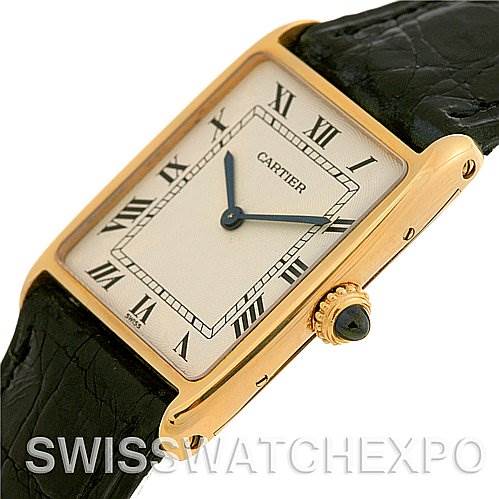 This image shows a Cartier Tank Classic 2466 Yellow Gold Silver Dial 2466 Yellow Gold Silver Dial watch from a tilted angle, highlighting the dial, crown, and part of the leather strap.