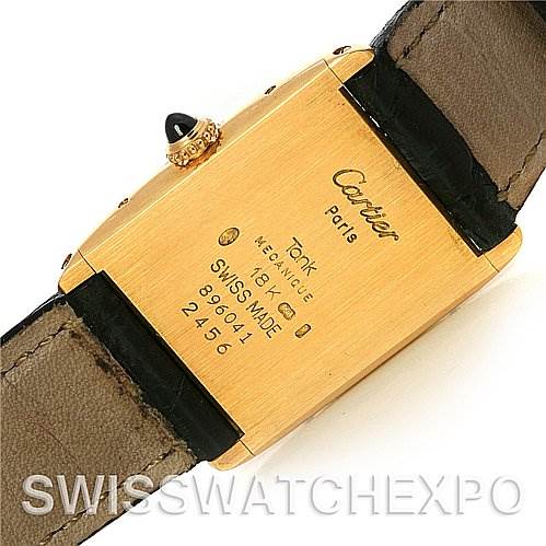The image shows the back view of a Cartier Tank Classic 2466 Yellow Gold Silver Dial 2466 Yellow Gold Silver Dial watch, highlighting the inscriptions and the leather strap.