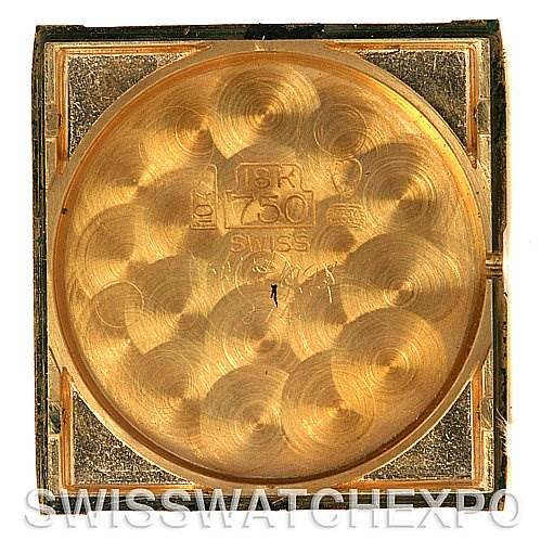 This is an overhead view of the internal case back of the Cartier Tank Classic 2466 Yellow Gold Silver Dial 2466 Yellow Gold Silver Dial watch, showcasing its 18K gold composition.