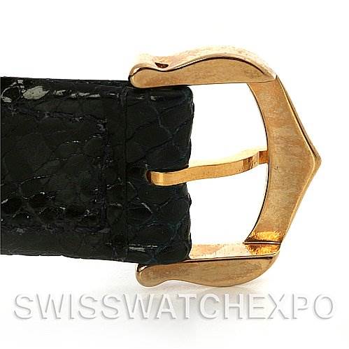 This image shows a close-up of the gold buckle and black leather strap of a Cartier Tank Classic Yellow Gold Blue Dial Yellow Gold Blue Dial watch.