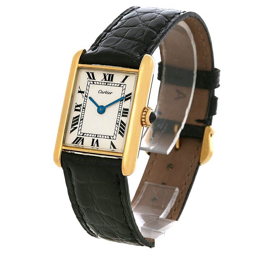The image shows a Tank Classic model watch by Cartier at a slight angle, displaying the face, bezel, crown, and black leather strap.