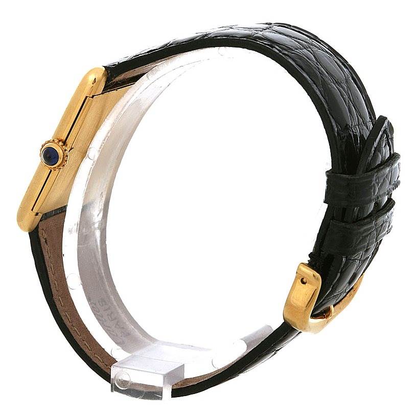 The image shows a side view of the Cartier Tank Classic Yellow Gold White Dial Yellow Gold White Dial watch, highlighting the gold case, crown, and black leather strap with a buckle.