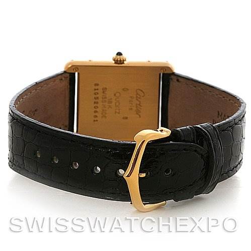 The image shows the back and clasp of a Cartier Tank Classic Yellow Gold White Dial Yellow Gold White Dial watch, highlighting the leather strap and case back.