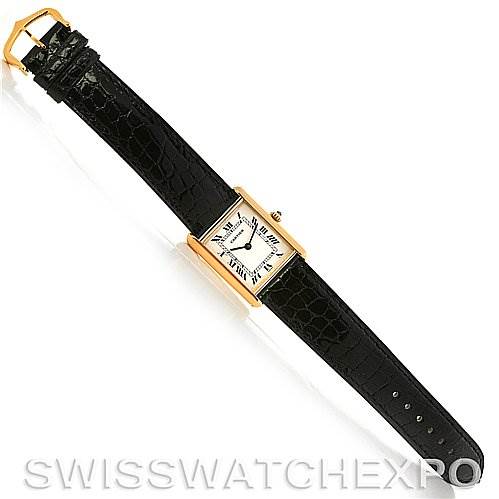 The image shows a top-down view of the Cartier Tank Classic Yellow Gold White Dial Yellow Gold White Dial watch with a gold case and black leather strap.