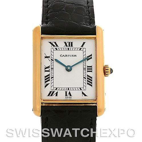 The image shows a frontal view of a Tank Classic model by Cartier, highlighting its rectangular face, Roman numerals, and black leather strap.