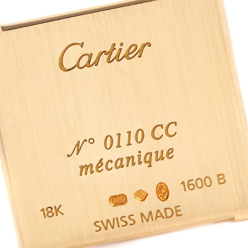 The image shows the back plate of a Cartier Tank Classic Men
s Yellow Gold Silver Dial Men
s Yellow Gold Silver Dial watch, detailing its specifications and engravings.