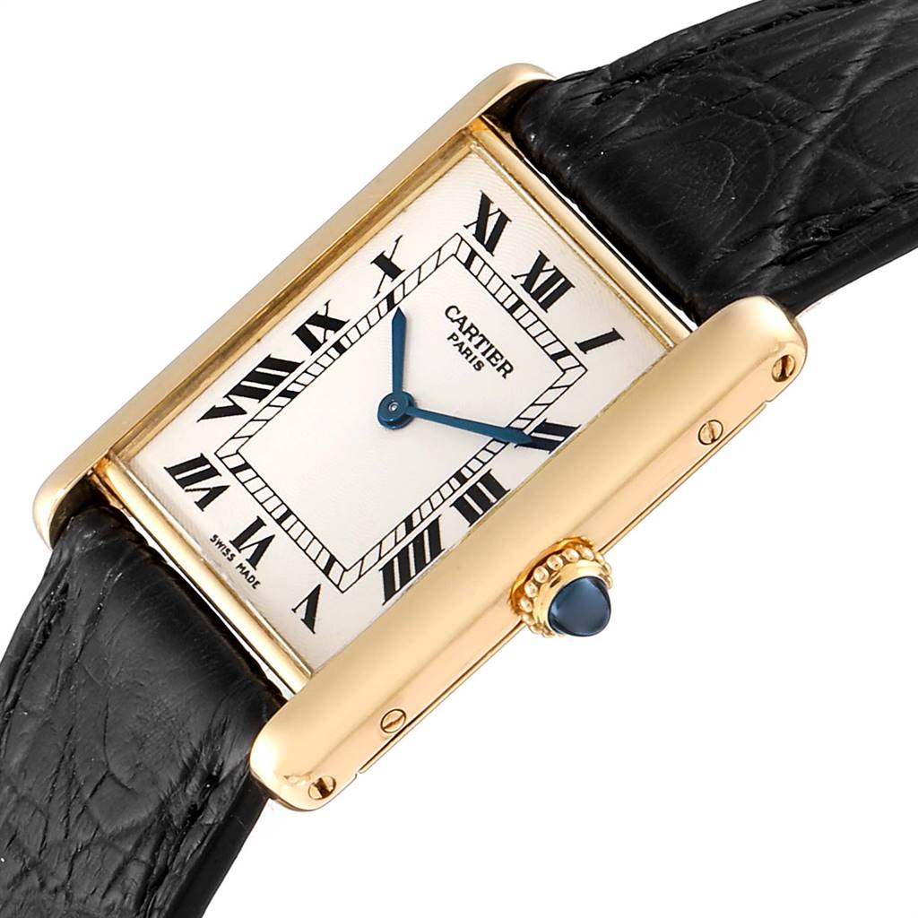 The Cartier Tank Classic Men
s Yellow Gold Silver Dial Men
s Yellow Gold Silver Dial watch is shown at an angle, featuring its rectangular dial, roman numerals, gold case, and black leather strap.