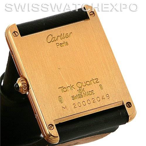 The image shows the backside of a Cartier Tank Classic Yellow Gold White Dial Yellow Gold White Dial watch, highlighting its square case and inscription details.
