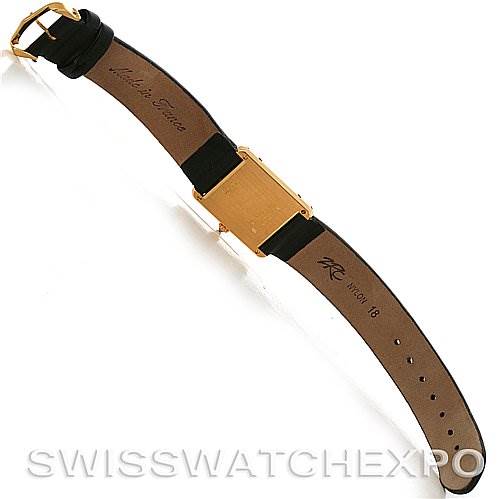 The image shows the back view of a Cartier Tank Classic Yellow Gold White Dial Yellow Gold White Dial watch, highlighting the leather strap and gold-tone case back.