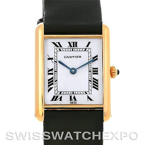 The image shows a front view of the Cartier Tank Classic Yellow Gold White Dial Yellow Gold White Dial model watch, highlighting its rectangular face, Roman numerals, and black strap.