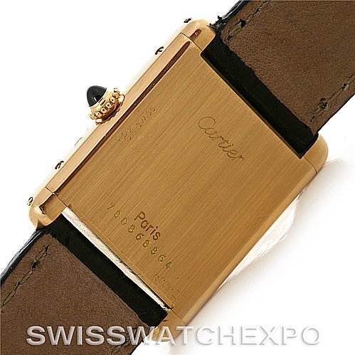 This image shows the back of a Cartier Tank Classic Yellow Gold White Dial Yellow Gold White Dial watch, highlighting the case back, crown, and leather strap.