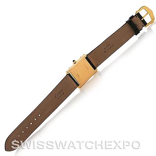 The image shows the underside of the Cartier Tank Classic Yellow Gold White Dial Yellow Gold White Dial watch, highlighting its leather strap and gold buckle.