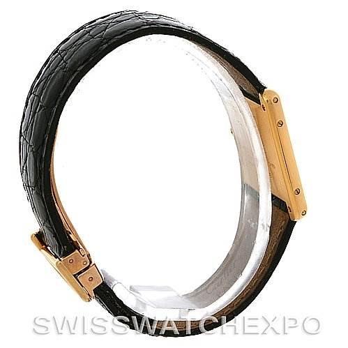 This image shows a side view of a Cartier Tank Classic Yellow Gold White Dial Yellow Gold White Dial watch, highlighting the black leather strap and the gold case.