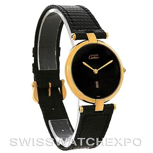 The image shows a side-angle view of a Cartier Tank Classic Yellow Gold Black Dial Yellow Gold Black Dial watch with a black dial, gold case, and black leather strap.