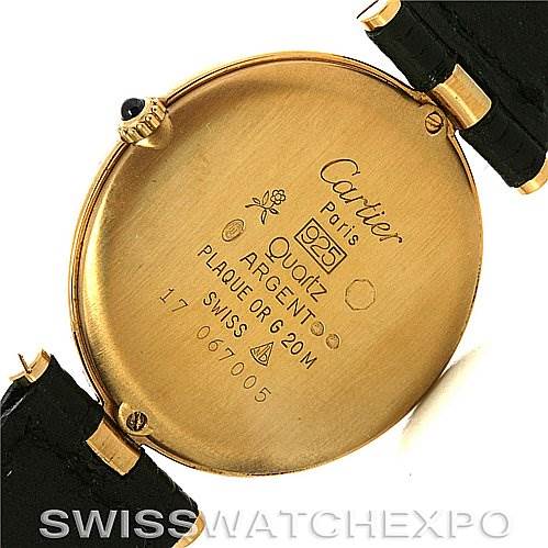 The image shows the back casing of a Cartier Tank Classic Yellow Gold Black Dial Yellow Gold Black Dial watch, detailing its engravings and strap attachments.