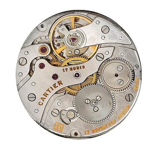 This image shows the internal mechanical movement of a Cartier Tank Classic Men's Platinum Silver Dial Men's Platinum Silver Dial watch, displaying gears, jewels, and various components from a top-down angle.