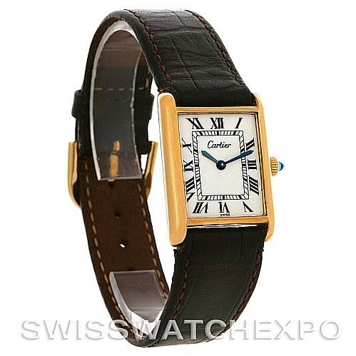 The image shows a Cartier Tank Classic Yellow Gold White Dial Yellow Gold White Dial model watch at a three-quarter angle, highlighting its dial, bezel, and leather strap.