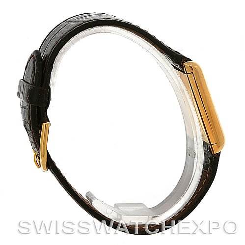 The image shows a side view of the Cartier Tank Classic Yellow Gold White Dial Yellow Gold White Dial model, highlighting its gold case and leather strap.