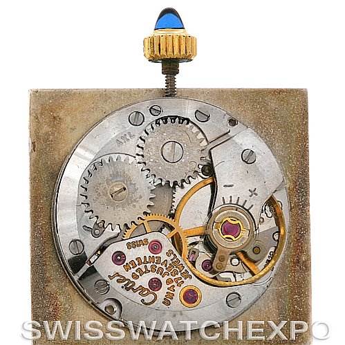 This image depicts the internal mechanical movement and parts of a Cartier Tank Classic Yellow Gold White Dial Yellow Gold White Dial watch, viewed from the back.