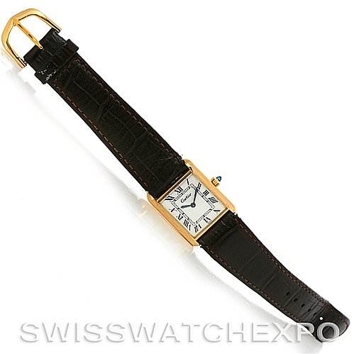 The Cartier Tank Classic Yellow Gold White Dial Yellow Gold White Dial watch is shown from a top-down angle, displaying the face, strap, and buckle.