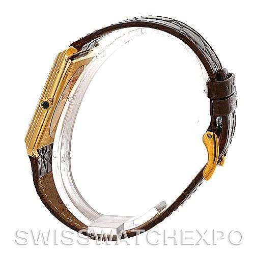 The image shows a side view of a Cartier Tank Classic Men's Yellow Gold White Dial Men's Yellow Gold White Dial model watch, highlighting its gold casing and brown leather strap.