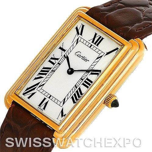 The image shows a close-up angled view of the Cartier Tank Classic Men's Yellow Gold White Dial Men's Yellow Gold White Dial watch, displaying the face, case, crown, and part of the leather strap.