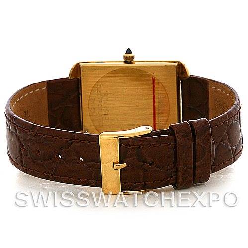 The image shows the back view of a Cartier Tank Classic Men's Yellow Gold White Dial Men's Yellow Gold White Dial watch with a brown leather strap and gold buckle.