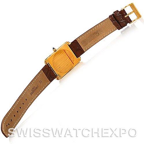 The image shows the back view of a Cartier Tank Classic Men's Yellow Gold White Dial Men's Yellow Gold White Dial model watch, displaying its leather strap and gold-tone buckle.