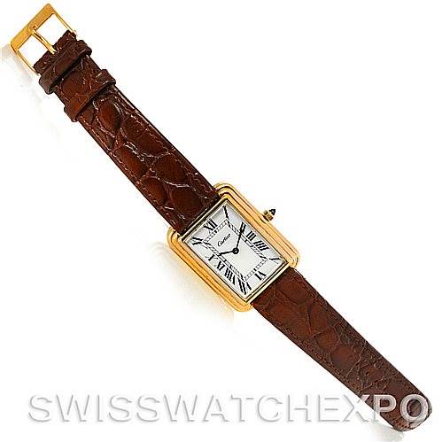 The image shows a top view of the Cartier Tank Classic Men's Yellow Gold White Dial Men's Yellow Gold White Dial model watch, featuring a rectangular case, leather strap, and Roman numeral dial.