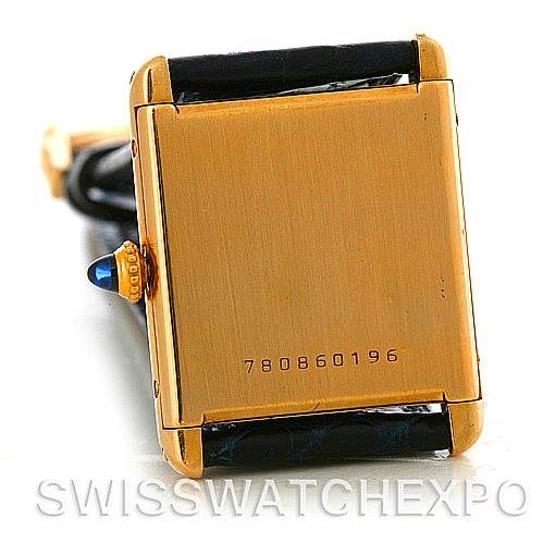 The image shows the back case and crown of a Cartier Tank Classic Yellow Gold White Dial Yellow Gold White Dial watch, featuring its serial number.