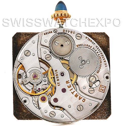 This image shows the internal mechanics and movement of a Cartier Tank Classic Men's Yellow Gold White Dial Men's Yellow Gold White Dial watch, focusing on gears and components.